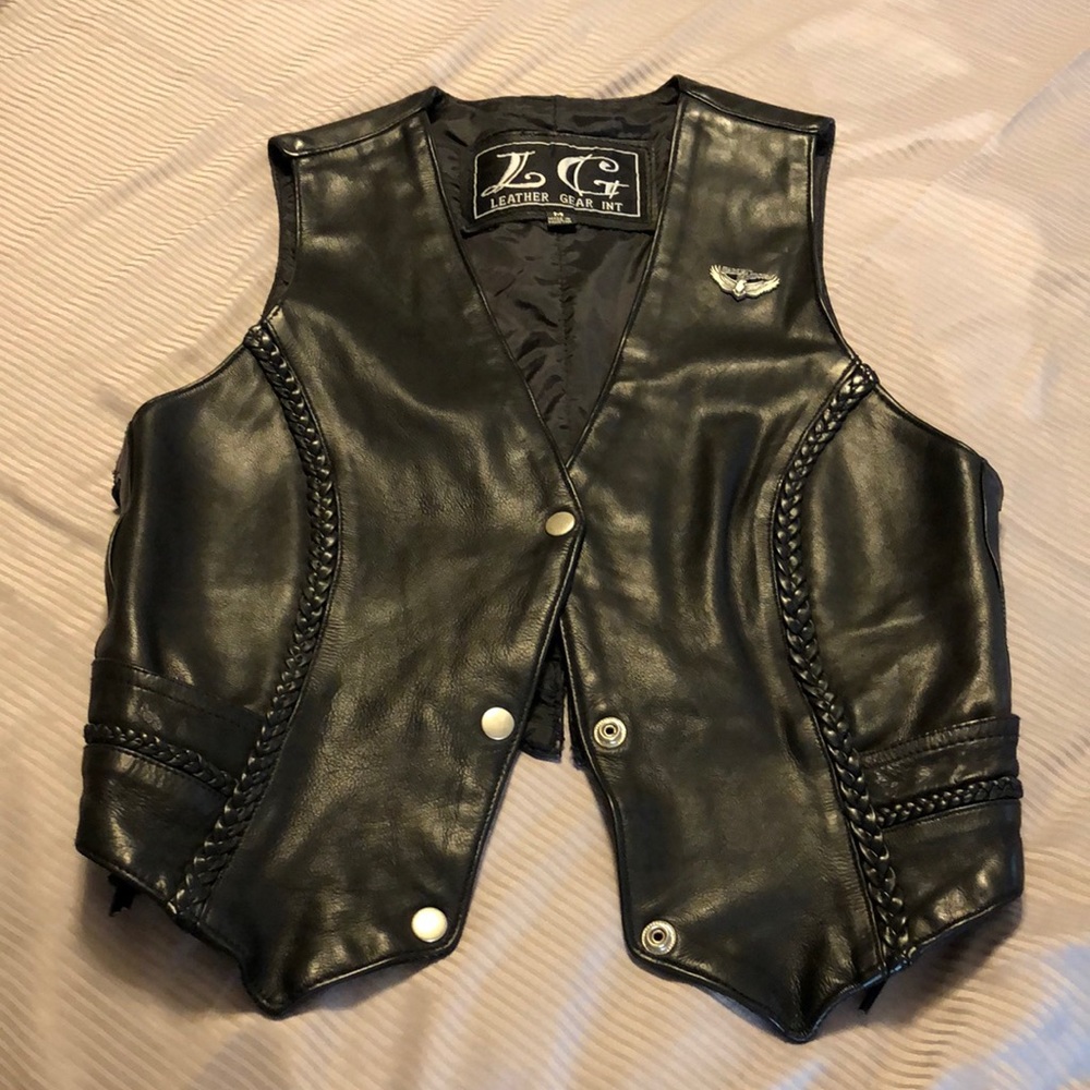 Black leather vest with braided trim. Sides adjust